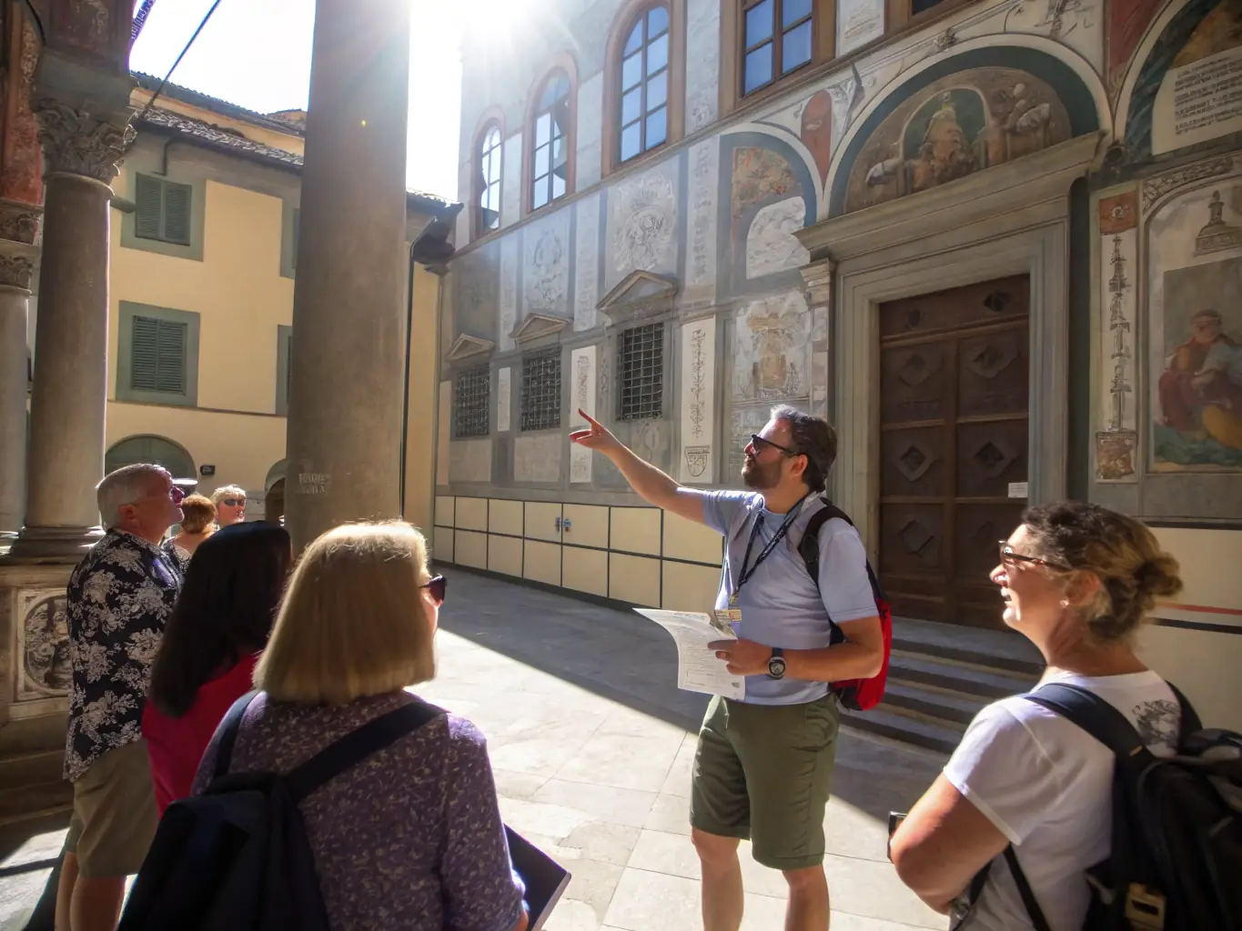 A photograph depicting a guided tour of Marcolès, showcasing the town's unique architectural features and historical landmarks. The tour guide is pointing out details to a group of interested tourists.